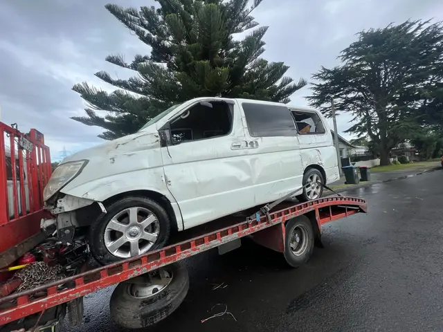 Damaged Nissan Elgrand loaded onto our tow truck in Wellington