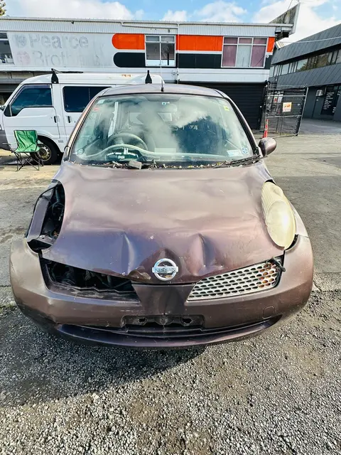 Brown Nissan March with smashed front end bought as scrap