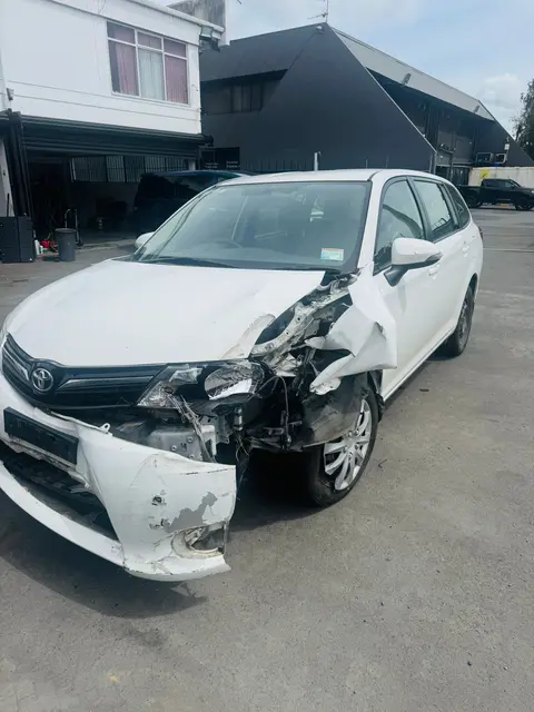 Toyota Corolla Fielder with damaged front bumper