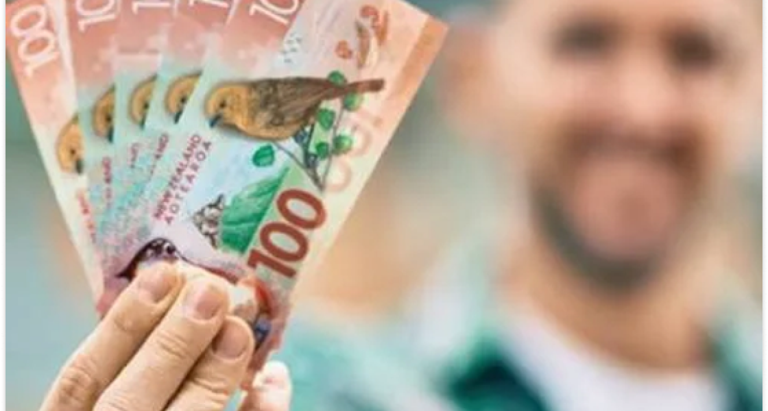 Customer holding instant cash after selling car in Wellington.